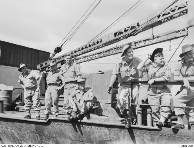 Unidentified Australian servicemen line the decks of the transport or troop ship T120 as it leaves the dock at Kure harbour, Japan, to participate in the first Australian operations in the Korean War.