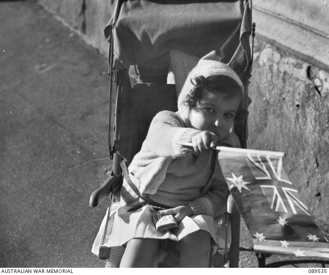 Girl waving a flag on VE Day 1945