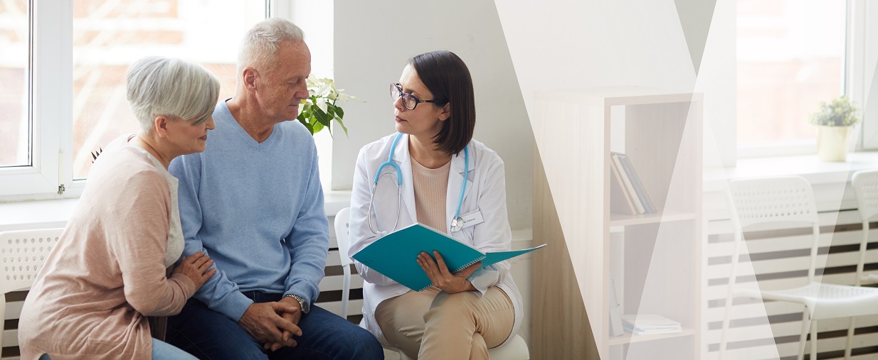A female doctor speaking with a senior couple.