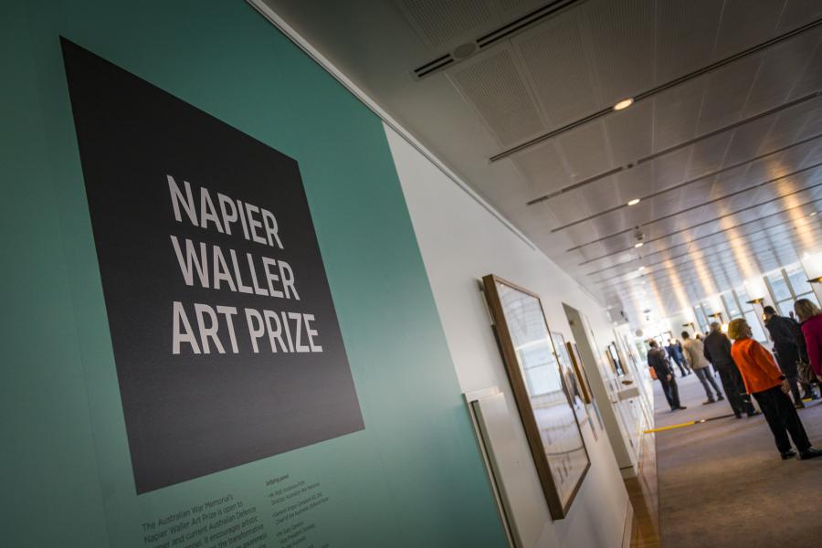 Gallery space with people milling and sign saying Napier Waller Art Prize