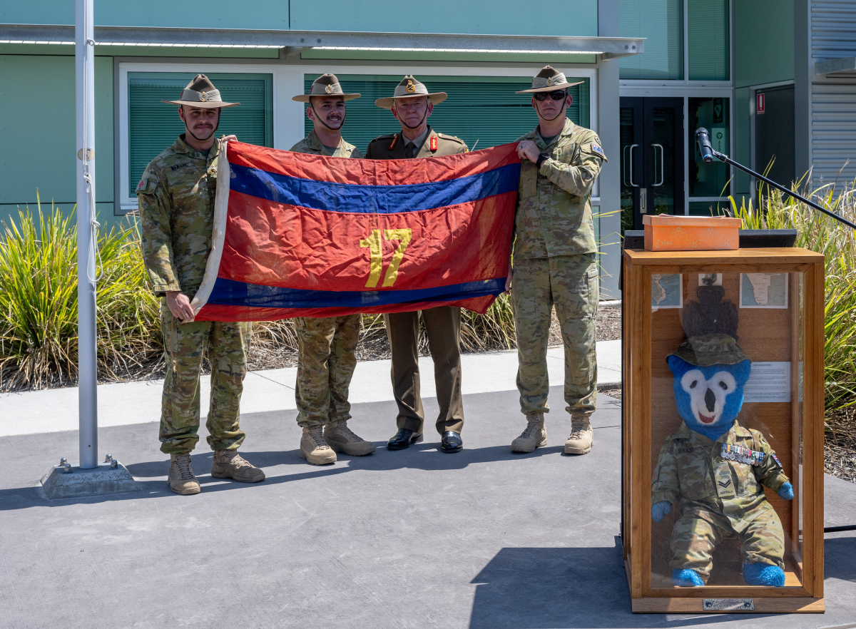 Soldiers display 17th Construction Squadron flag from the Vietenam War