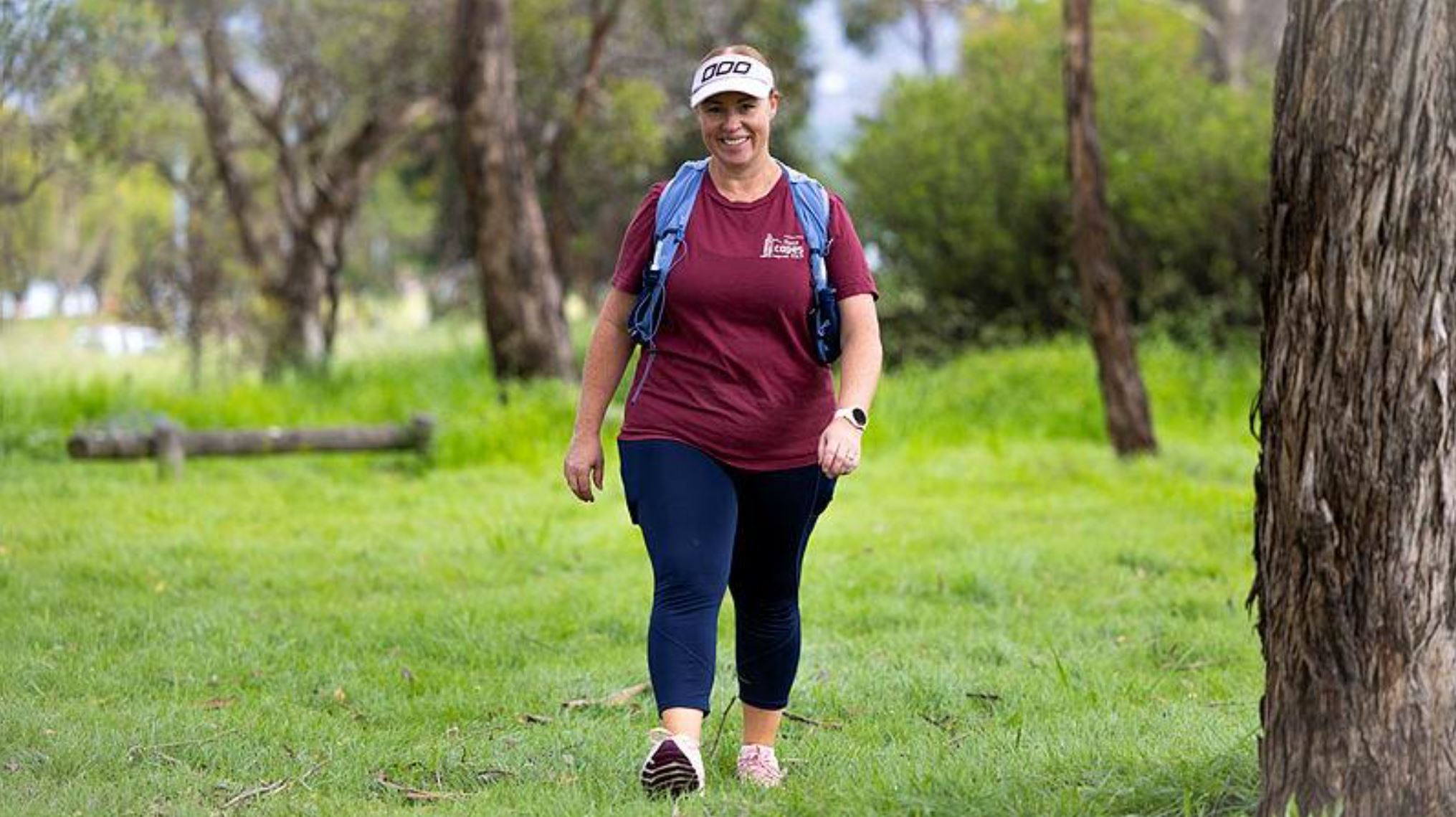 Smiling woman walks through the bush