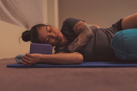 Person sleeping on yoga matt