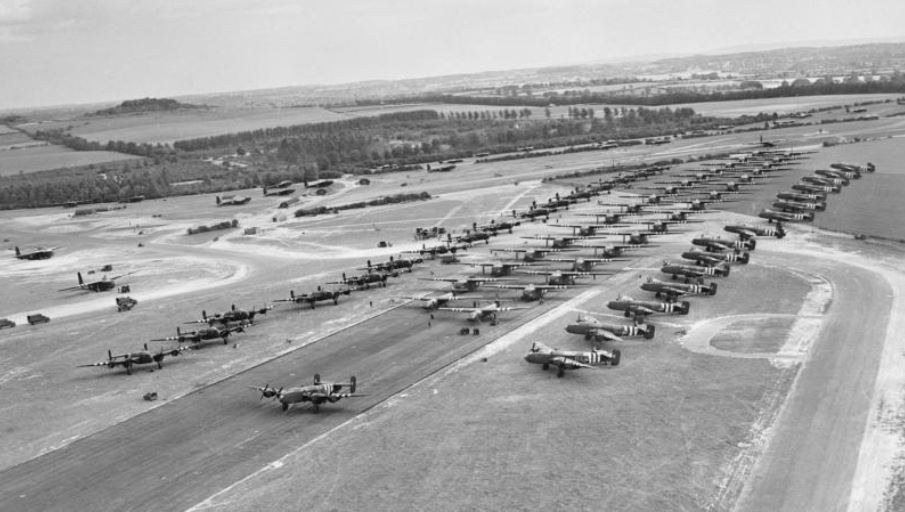 Dozens of Halifax bombers lined up on or next to a runway