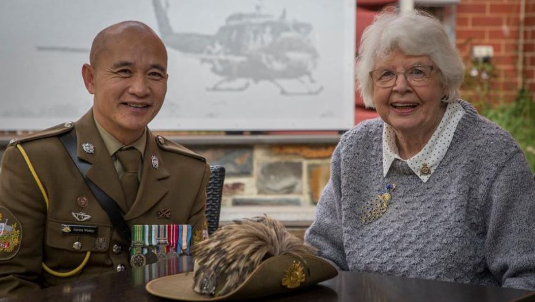 Warrant Officer in uniform poses with elderly woman