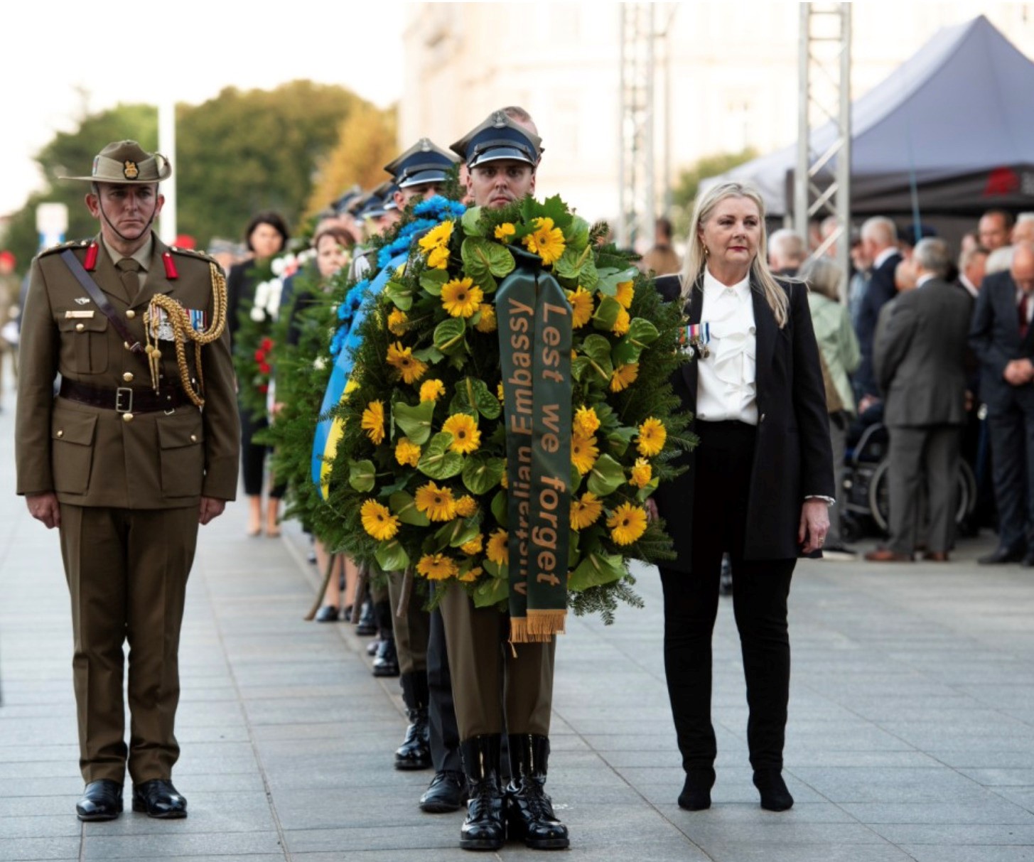 The Guard of Honour carries the Australian Embassy’s wreath, flanked by Jennifer Gorrie and Australian Defence Attaché Colonel Paul Graham.