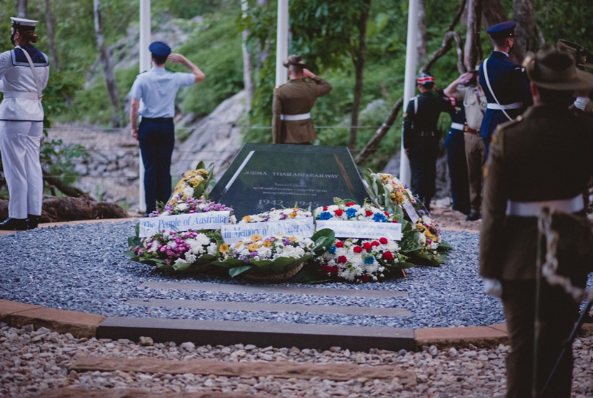 Army and navy officers saluting at the war grave