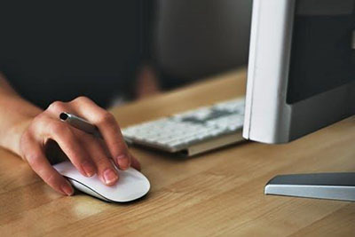 Hand holding a computer mouse