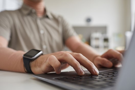 Man typing on laptop