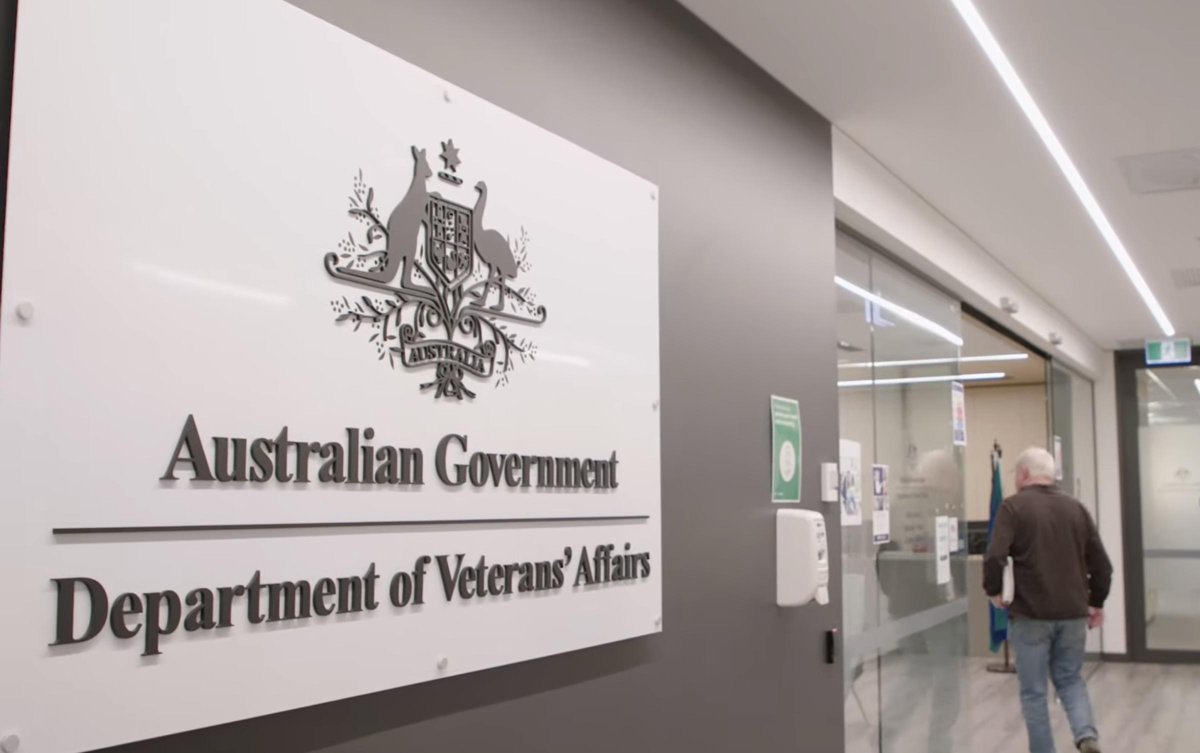 A man walks past the Department of Veterans' Affairs sign into a Veteran Access Network location
