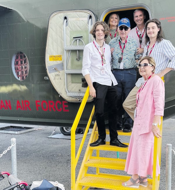 A family of six pose for photo at door of Caribo aircraft