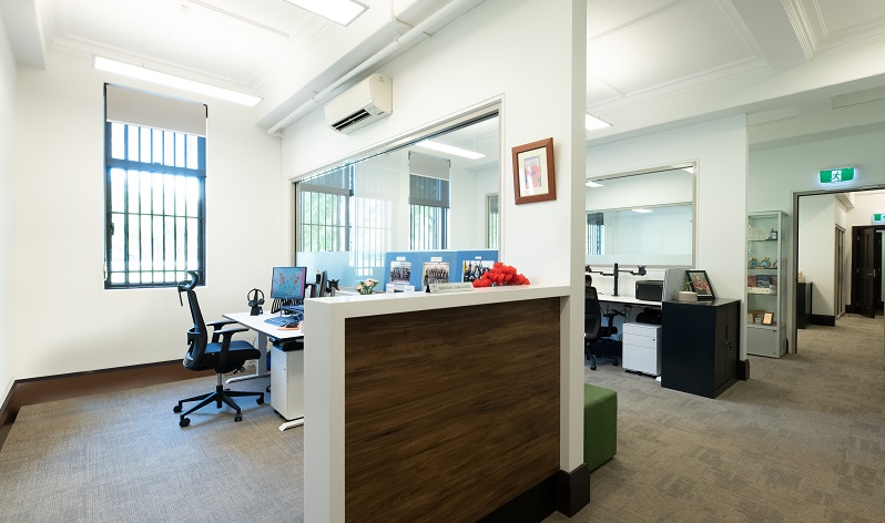 Entrance to spacious, well-lit office space with Legacy logo on glass door