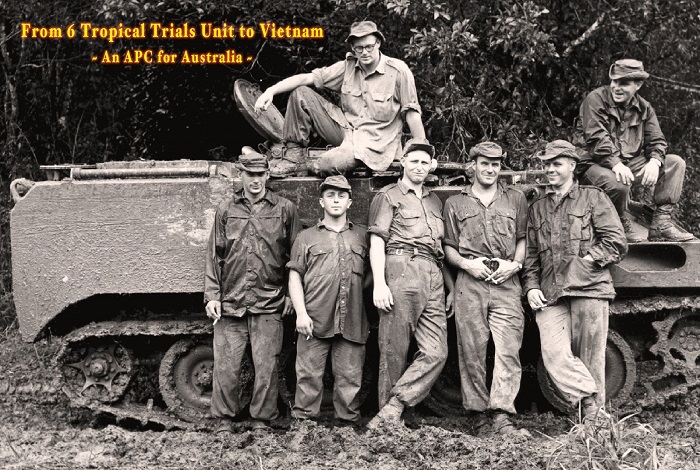 Seven soldiers posing next to armoured personnel carrier