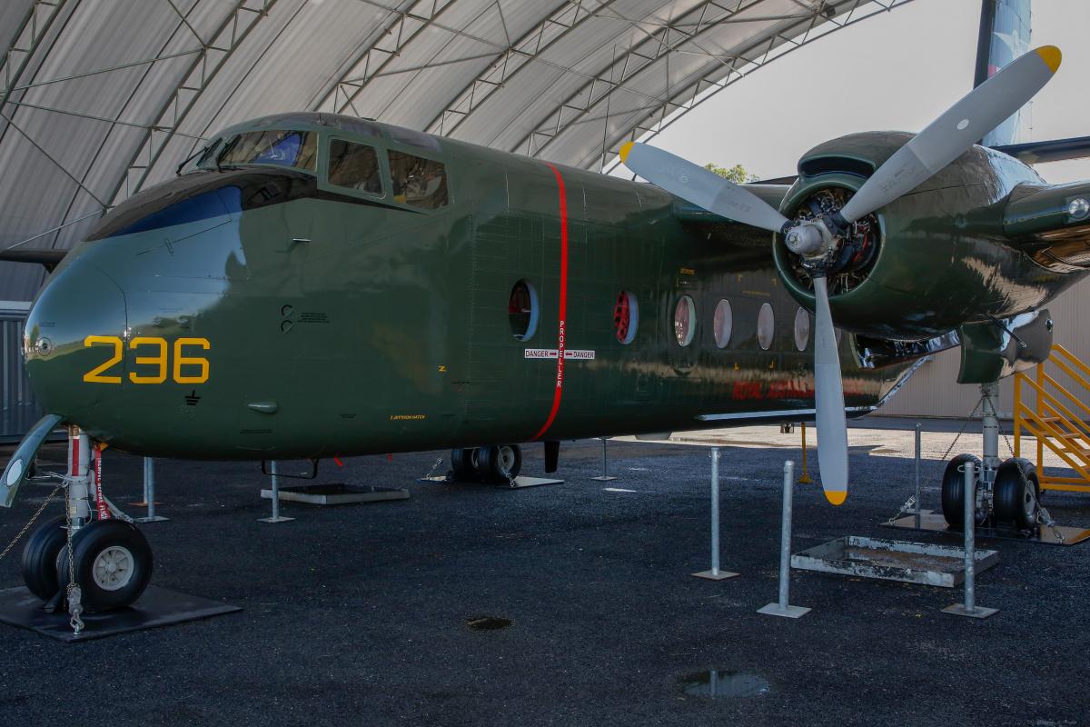 Green propeller airplane in hangar