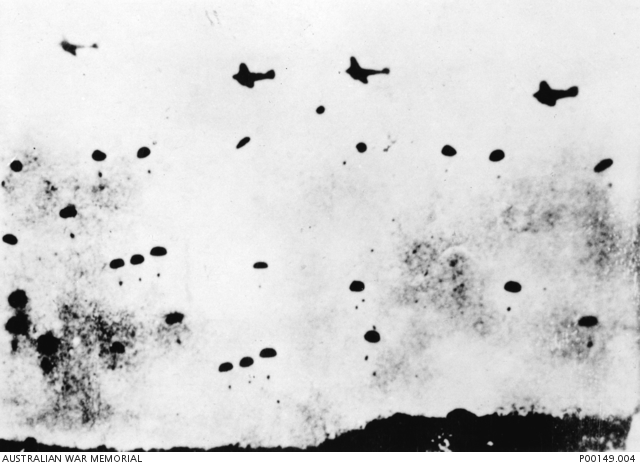 blurry shot of planes dropping parachutists
