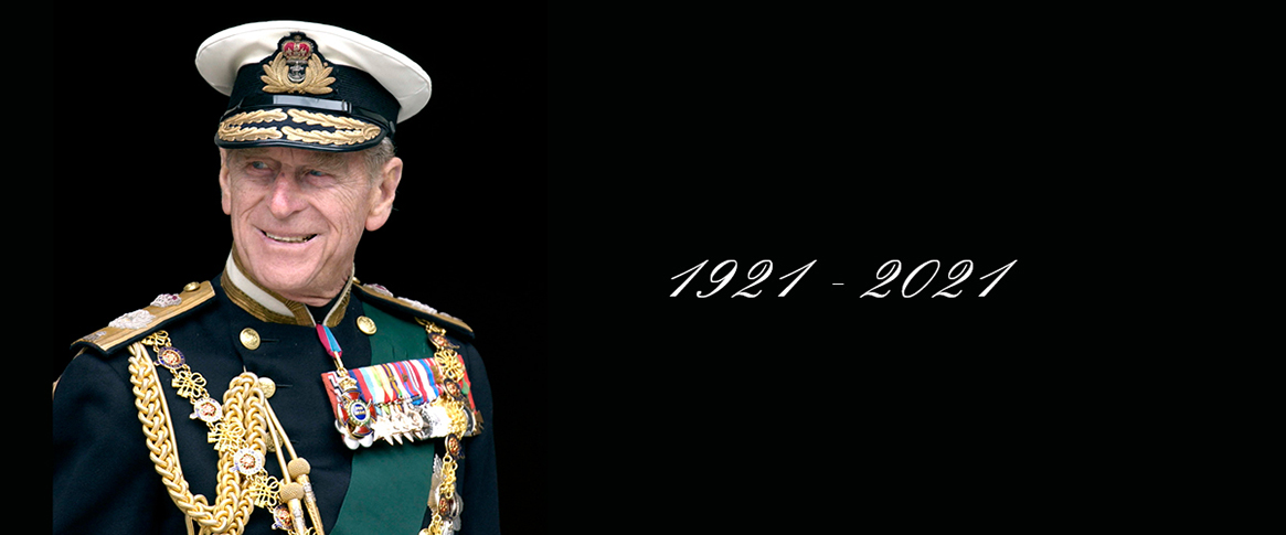 A smiling elderly Prince Philip in full dress uniform with a lifespan from 1921 to 2021.