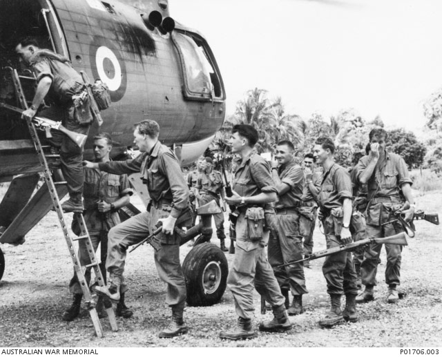 Australian military personnel at Arawak, Borneo, boarding a helicopter for transport to a jungle, 1965.