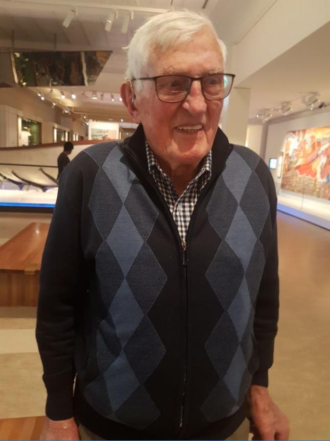 Elderly man smiling in a museum