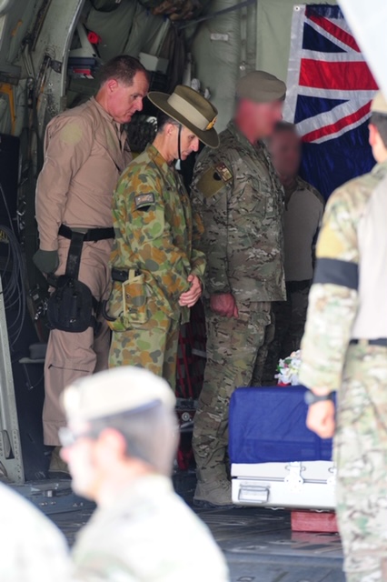 Defence Engagement Commissioner Stuart Smith taking part in a Ramp Ceremony for an Australian soldier, Tarin Kowt, Afghanistan, 2012
