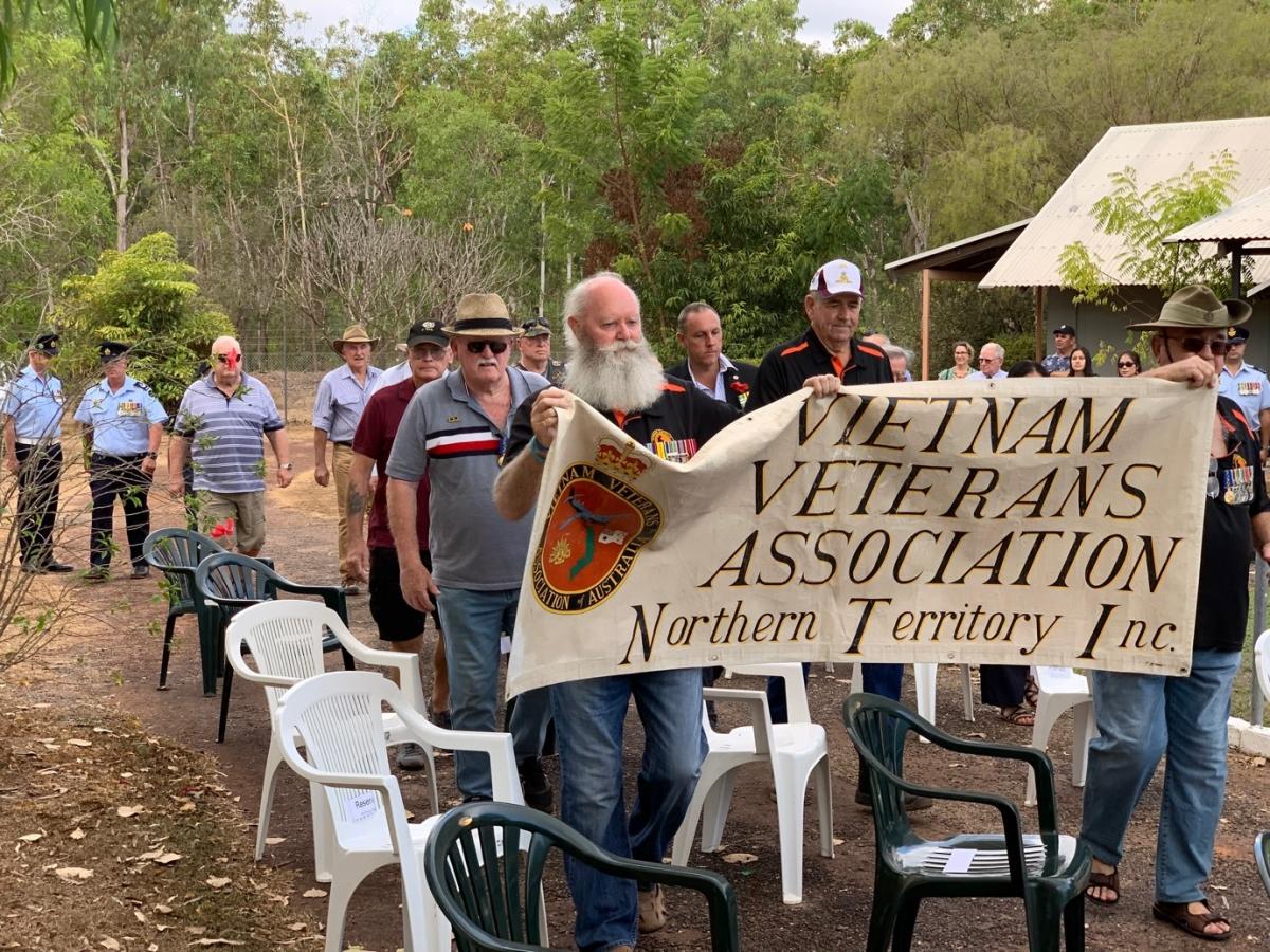Men march holding a banner saying Vietnam Veterans Association NT