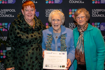 three women with one holding a certificate saying ‘Congratulations War Widows Guild of Australia NSW.’