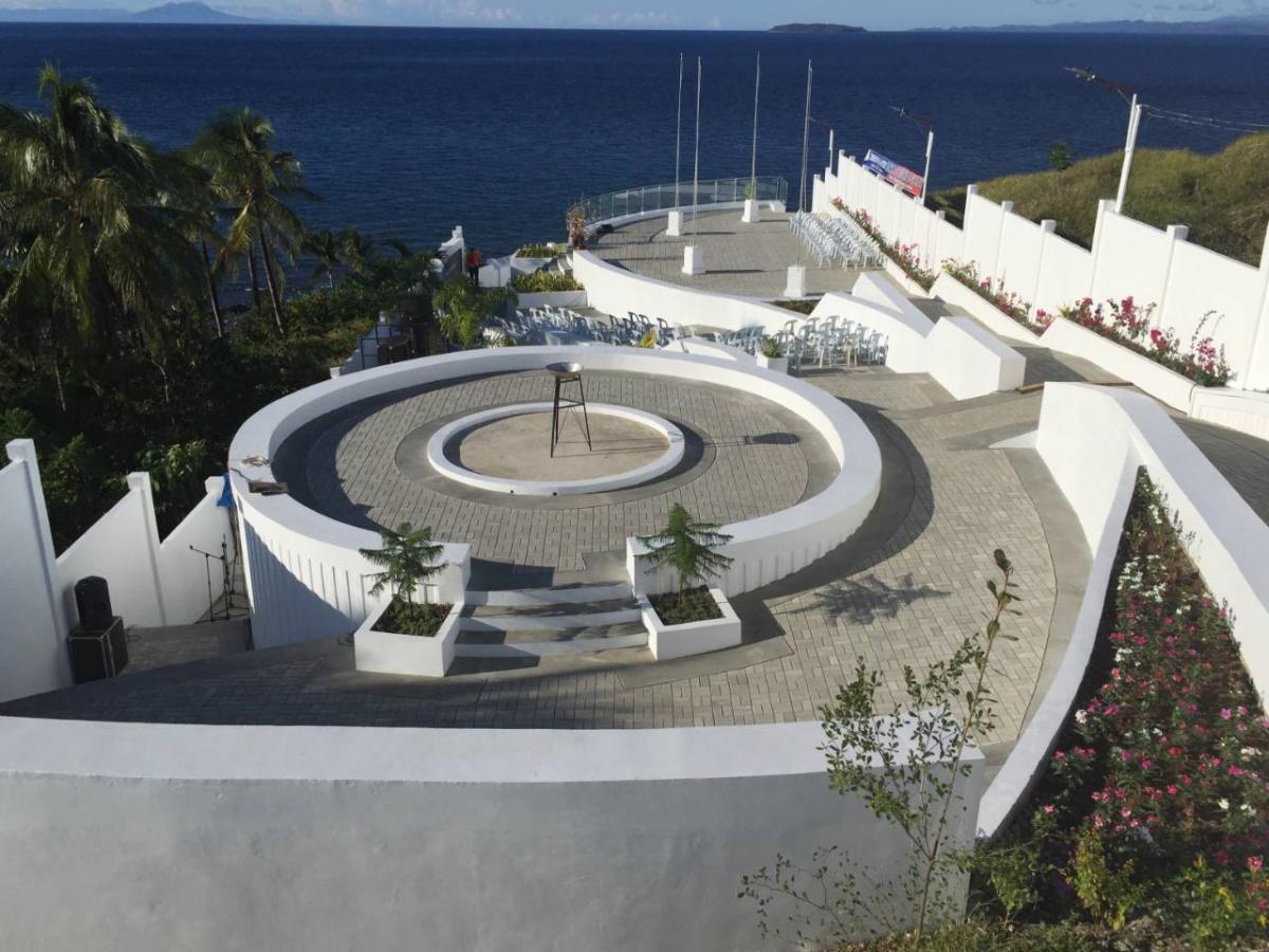 A war memorial made up of curved and circular white walls and walkways.