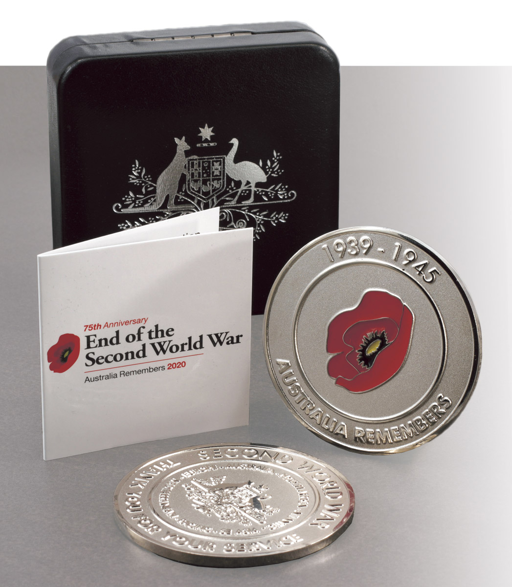 Close-up of the commemorative medallion (front and back) with the black display case and card.