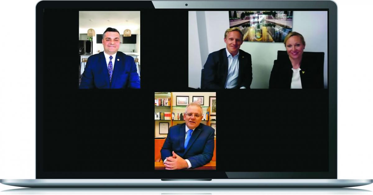 A laptop displaying four smiling people in a Skype video call during the 2020 Prime Minister’s Veterans’ Employment Awards online announcement. They are Scott Morrison, Prime Minister of Australia, Adam Frizell and Emily Frizell from AeroPM who won the Outstanding Veterans’ Employer of the Year Award and Davor Strbac from Suncorp who won the Veteran Employee of the Year Award.