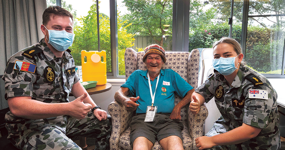 Able Seaman Medics Aaron Jones (left) and Riley Hansen (right) with Montfort Adams at Jonathan Rogers GC House in Nowra, NSW. The ADF is supporting the COVID-19 vaccine roll-out in aged-care and disability facilities. Photo: Department of Defence