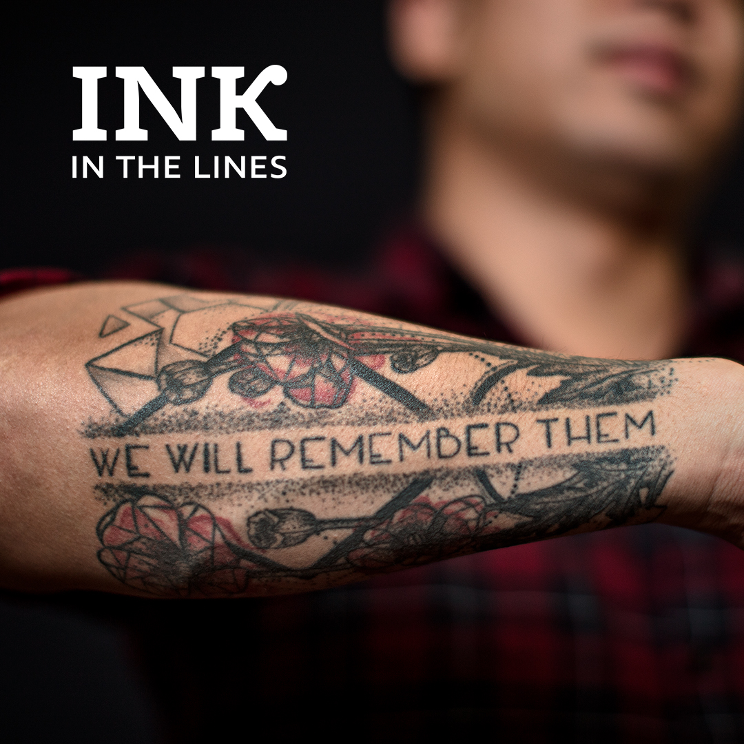 Photo of man’s arm tattooed with the words ‘We will remember them.’