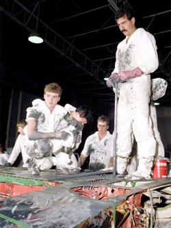 Fuel tank maintenance workers wearing dirty overalls