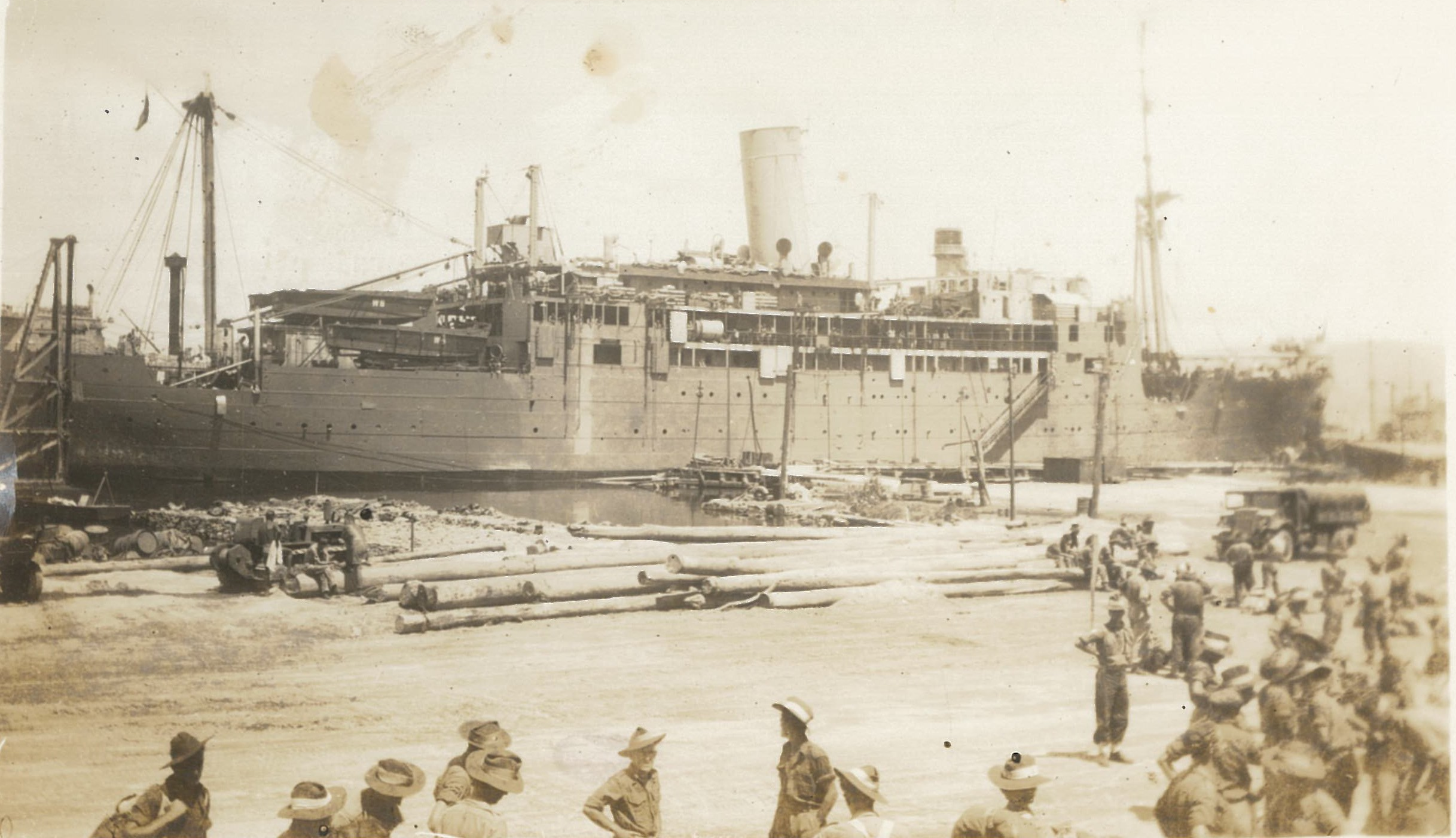 Japanese prisoners of war alighting a Japanese vessel at Rabaul, New Guinea, after surrendering and handing over their weapons, which were dumped into the harbour.