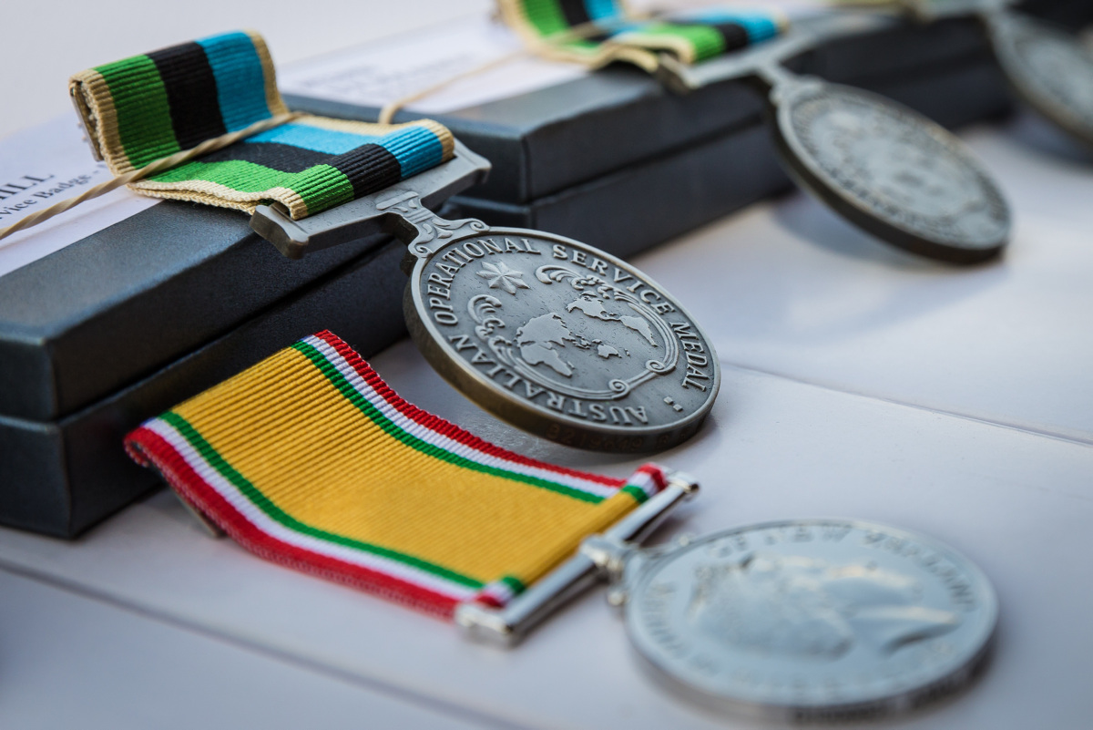 A row of medals on a table.