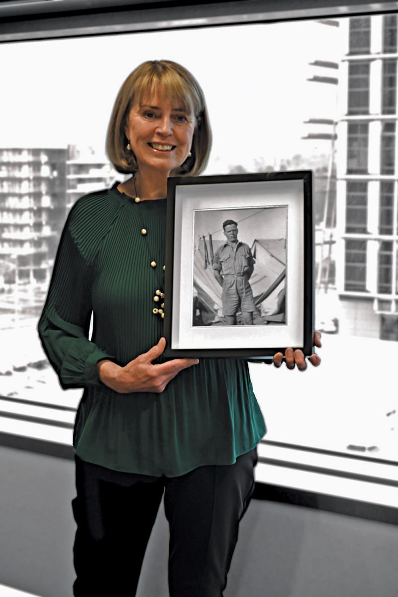 Ms Rundle with a photograph of her father who served in the Middle East in the Army during the Second World War.