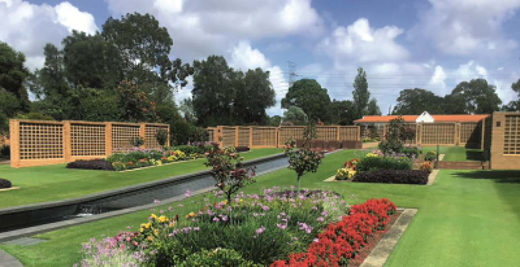 Cemetery garden with flowers in foreground