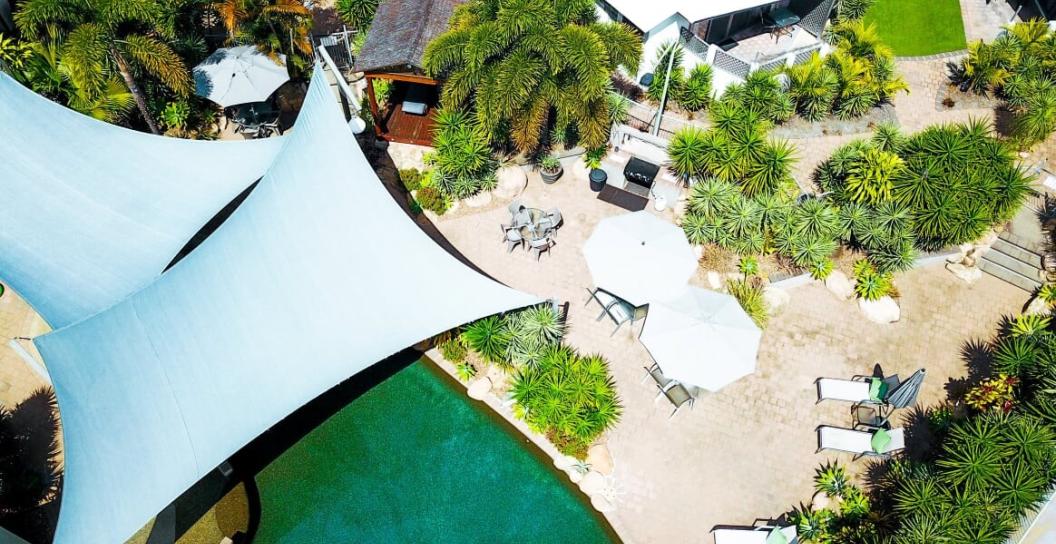 aerial shot of resort with swimming pool and sun shades