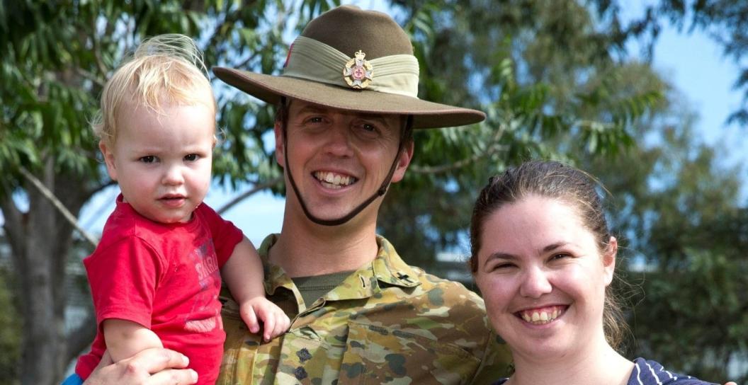 Army captain with female partner and toddler son all smiling