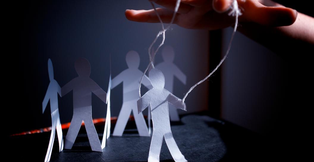 Paper cut outs of people with strings attached like puppets
