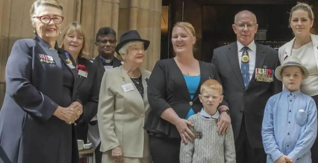 A gathering of women and a few children outside a church, with the Governor-General in the centre