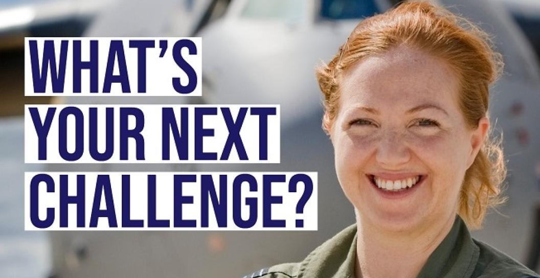 Smiling female RAAF officer standing in front of cargo plane with slogan saying 'What's your next challenge?'