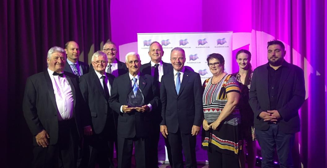 Ten people posing for camera at awards event.