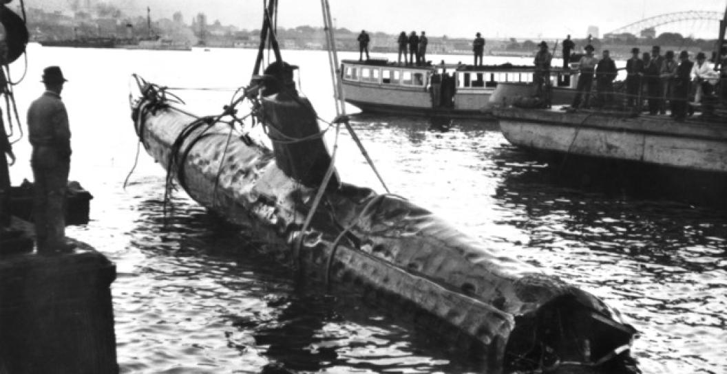 Several men watch as a Japanese midget two-man submarine is raised from the Sydney harbour bed, 1942.