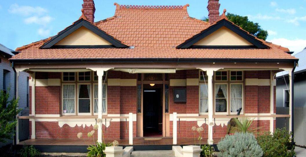 Front-on photo of red-brick and tiled cottage