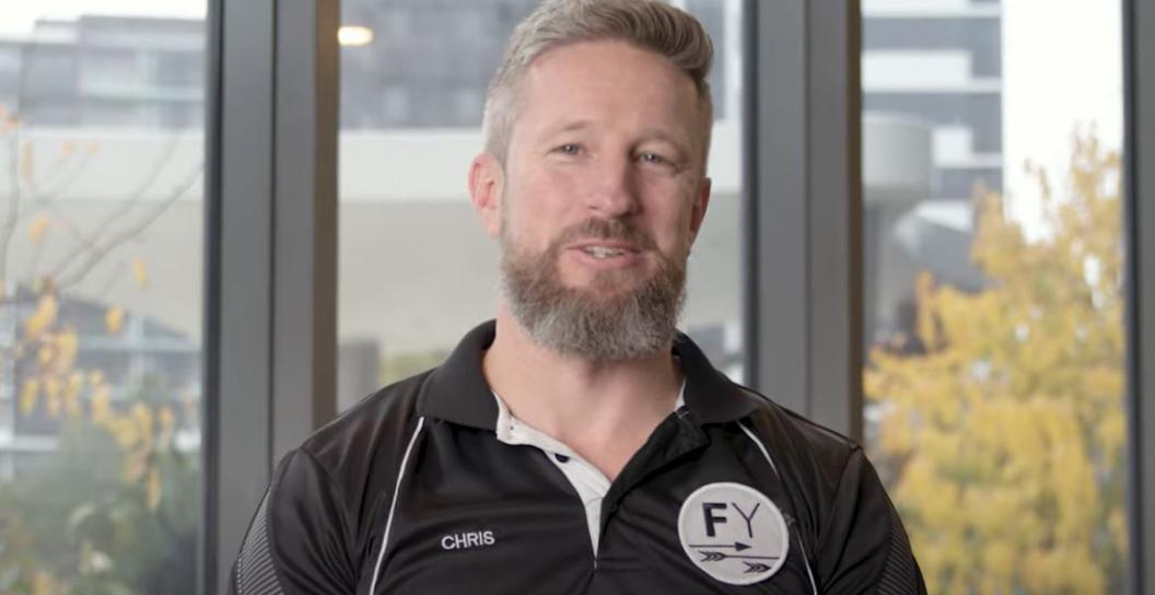 Portrait photo of young bearded man wearing Frontline Yoga T-shirt