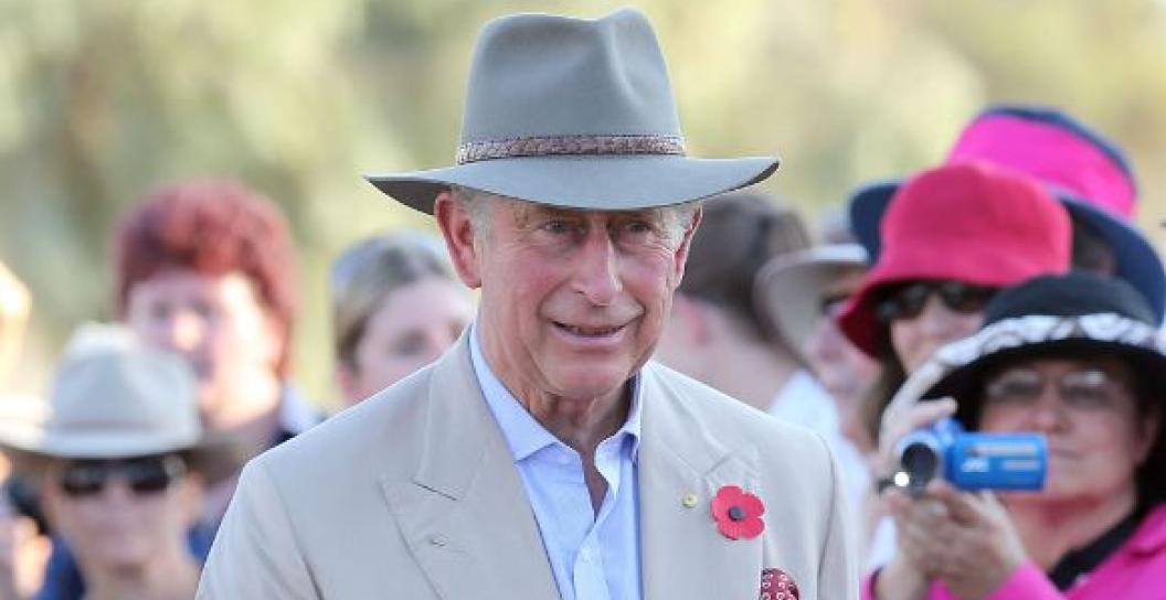 Prince Charles wearing an Akubra with a crowd behind him taking photos