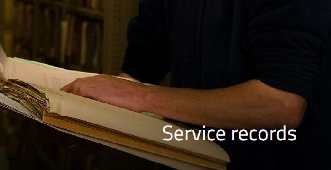 Stock photo of man examining records in an archive
