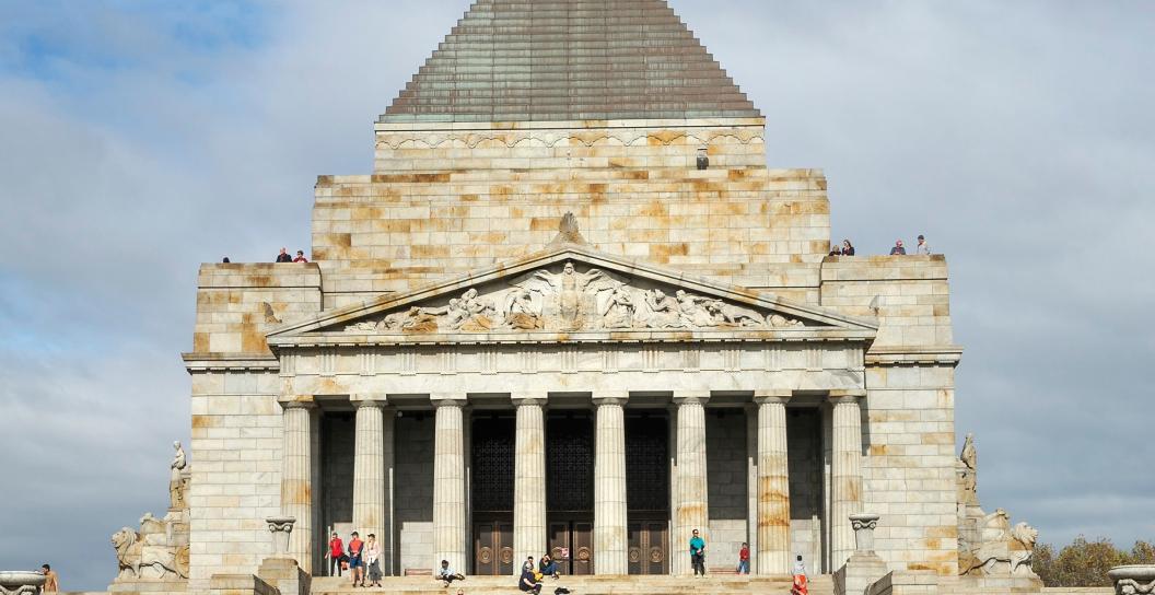 A large shrine with people standing on the steps in front of it