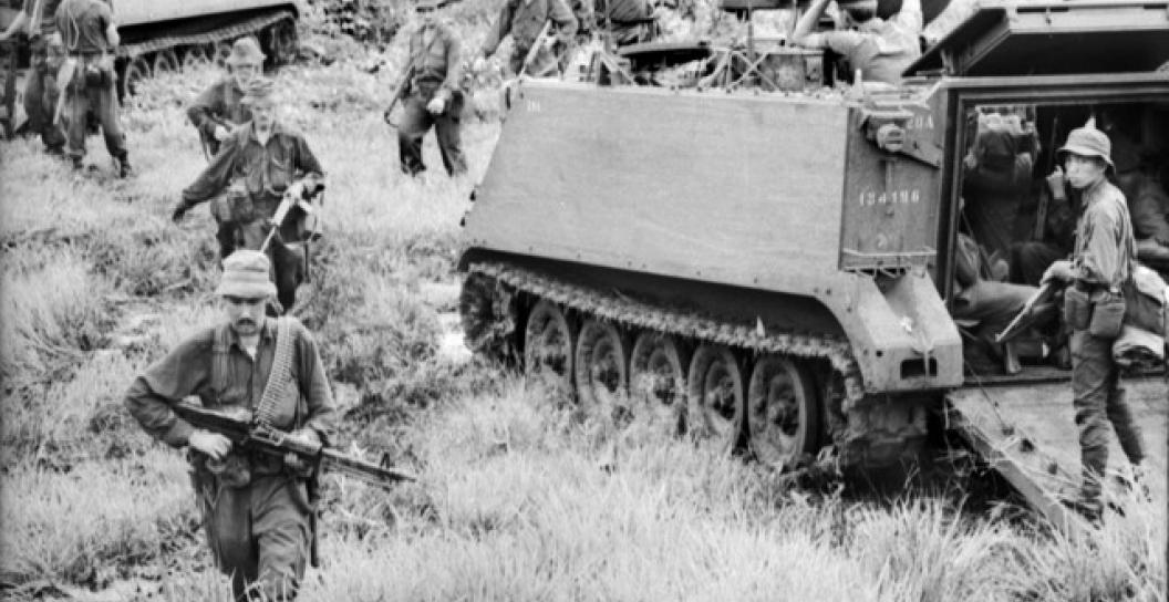 During Operation Smithfield, armoured personnel carriers of 1 APC Squadron and troops on foot sweep along in pursuit of retreating Viet Cong in Phuoc Tuy Province after the Battle of Long Tan.
