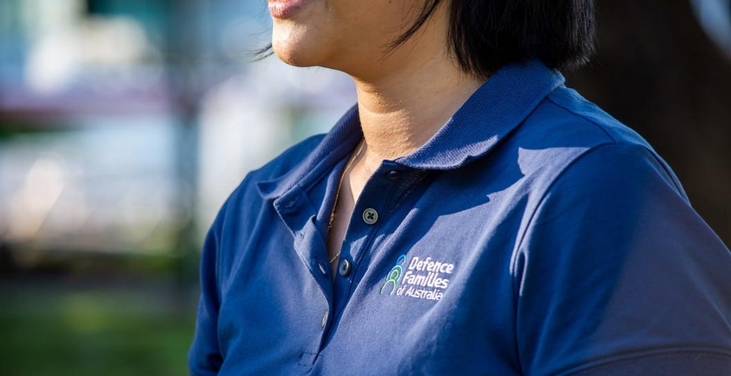 Photo of woman wearing T-shirt that has Defence Families Australia logo