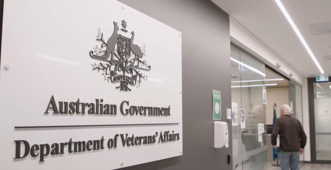 A man walks past the Department of Veterans' Affairs sign into a Veteran Access Network location